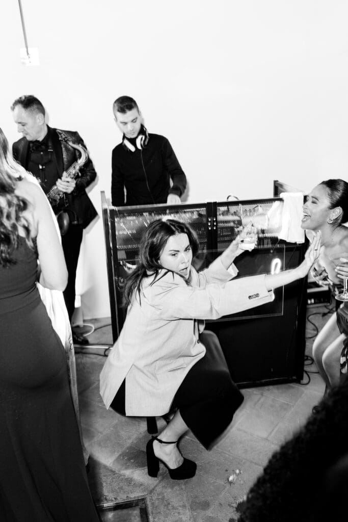 Guests on the dance floor receiving cannoli from a cone